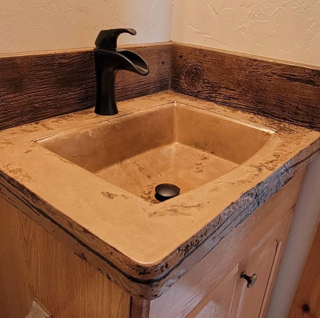 Light brown stained custom sink and surround with dark handle - KreteworX Idaho Falls countertops.